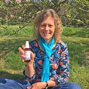 Picture of Catherine Keattch holding a bottle of flower essences